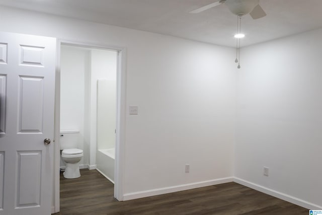 interior space with connected bathroom, dark hardwood / wood-style flooring, and ceiling fan