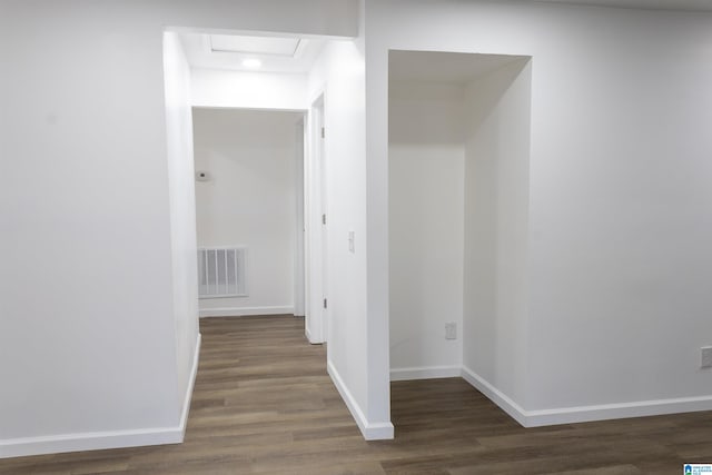 corridor featuring dark hardwood / wood-style flooring