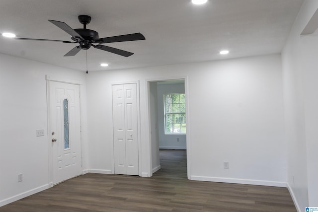 unfurnished bedroom with ceiling fan and dark wood-type flooring