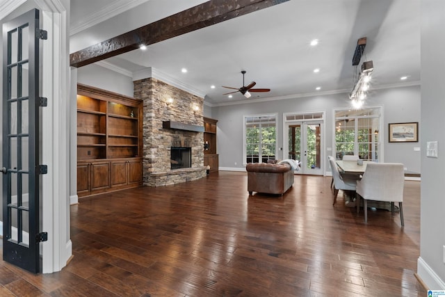 living room with a stone fireplace, dark hardwood / wood-style flooring, ceiling fan, and french doors