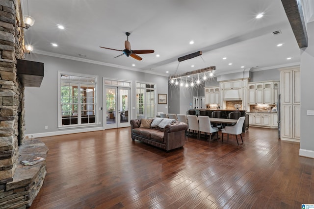 living room with ceiling fan, crown molding, and dark wood-type flooring