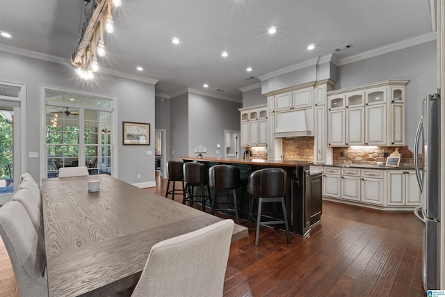 dining room featuring ornamental molding, dark hardwood / wood-style floors, and ceiling fan