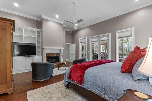 bedroom featuring dark wood-type flooring, a fireplace, crown molding, ceiling fan, and access to outside