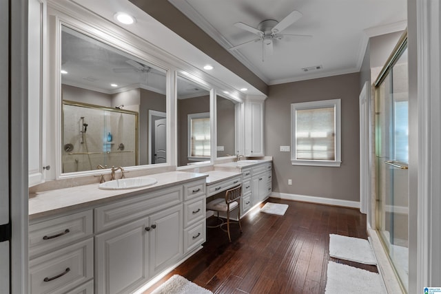 bathroom with a healthy amount of sunlight, vanity, ceiling fan, and a shower with door