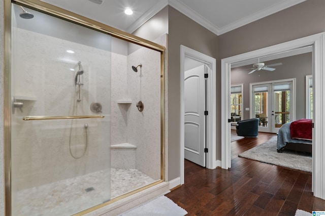 bathroom featuring french doors, hardwood / wood-style flooring, and a shower with shower door