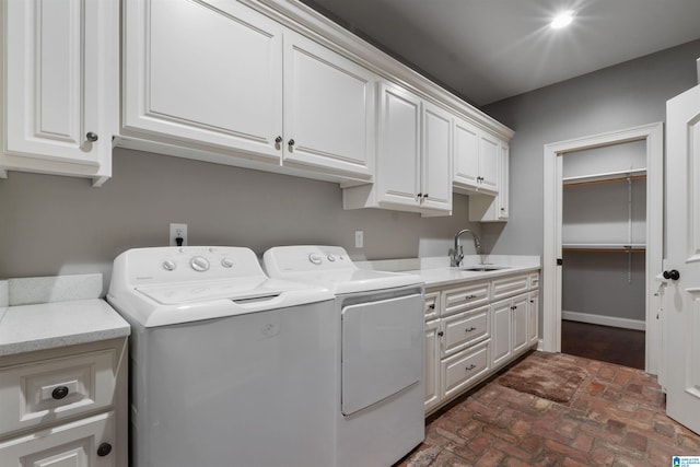 washroom featuring cabinets, separate washer and dryer, and sink