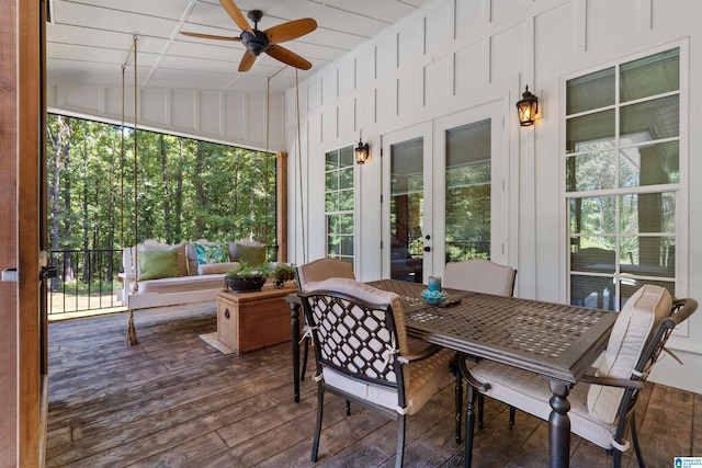 sunroom featuring vaulted ceiling, ceiling fan, and plenty of natural light