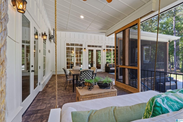 sunroom / solarium featuring french doors