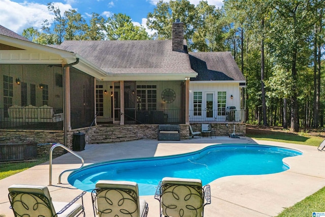 view of pool with french doors and a patio area