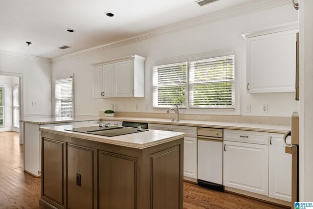 kitchen featuring a healthy amount of sunlight, a kitchen island, dark wood-type flooring, and white cabinets