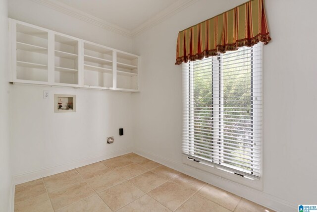 laundry area featuring ornamental molding, washer hookup, and light tile patterned flooring