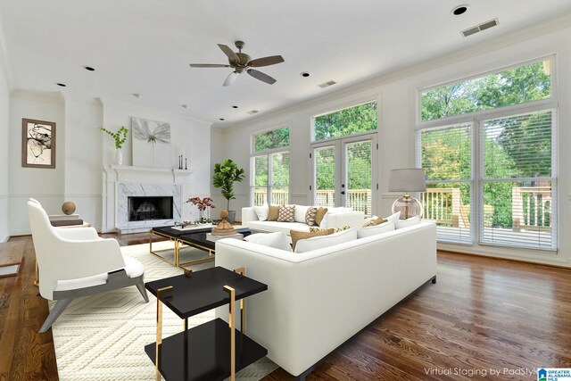 living room with a fireplace, crown molding, ceiling fan, french doors, and dark hardwood / wood-style floors