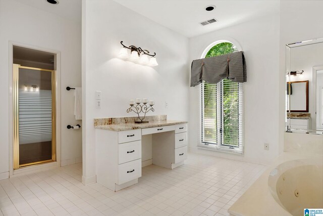 bathroom featuring shower with separate bathtub, tile patterned floors, and vanity