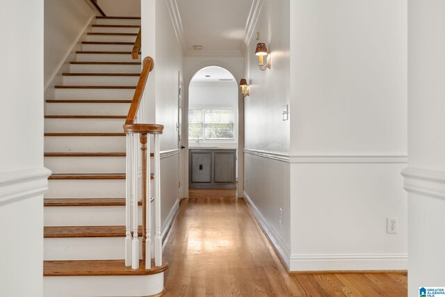 interior space with ornamental molding and hardwood / wood-style floors