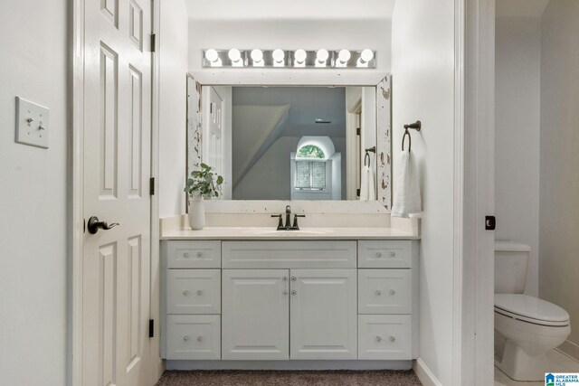 bathroom featuring vanity and toilet