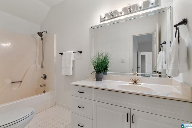 full bathroom with vaulted ceiling, vanity, tile patterned flooring, toilet, and  shower combination