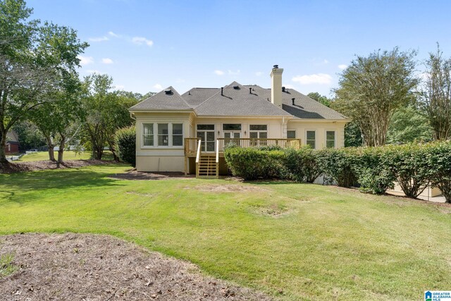 back of house featuring a deck and a yard