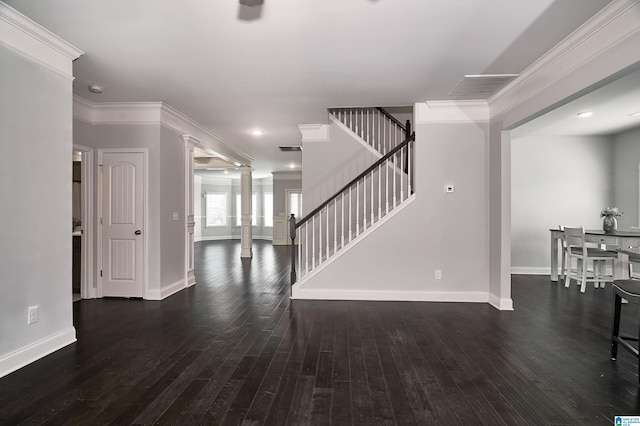 entryway featuring dark hardwood / wood-style floors, ornate columns, and crown molding