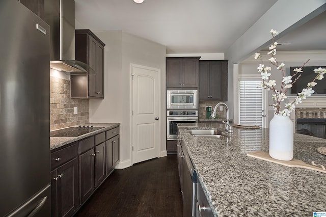 kitchen with appliances with stainless steel finishes, backsplash, sink, and dark hardwood / wood-style flooring