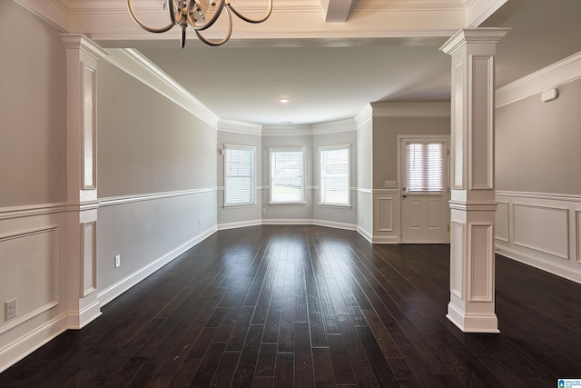 unfurnished room with ornamental molding, decorative columns, dark hardwood / wood-style flooring, and a chandelier