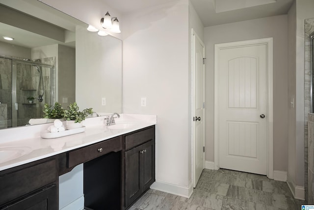 bathroom featuring vanity and a shower with shower door