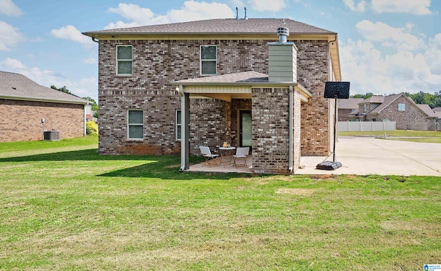 back of property with a lawn, a patio, and cooling unit