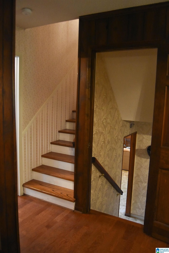 stairs featuring wood-type flooring