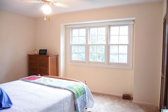 bedroom with carpet flooring, multiple windows, and ceiling fan