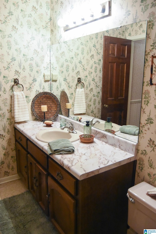 bathroom featuring vanity and toilet