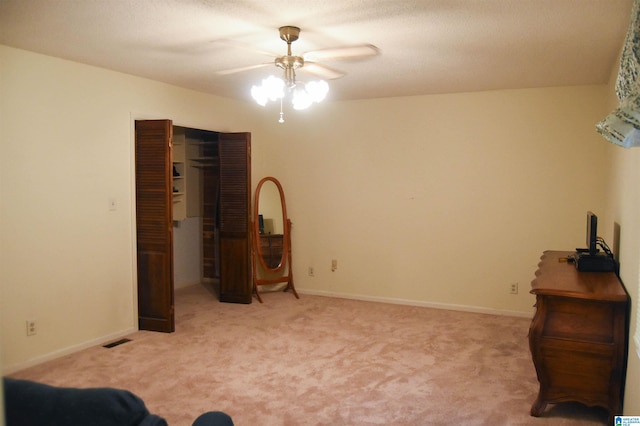 bedroom featuring a closet, ceiling fan, and light colored carpet