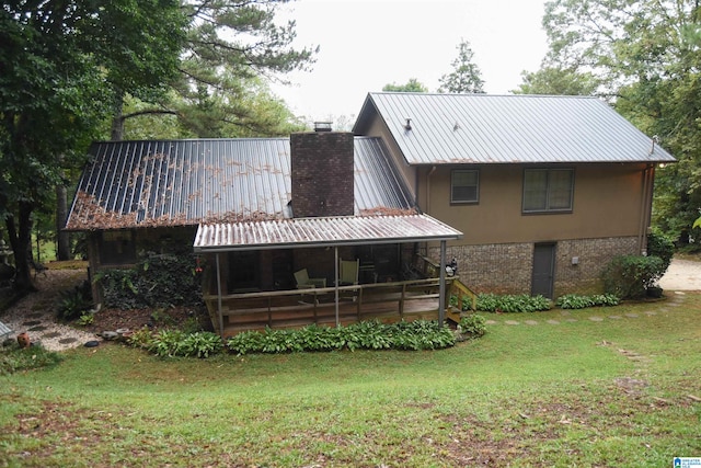 rear view of house with a lawn