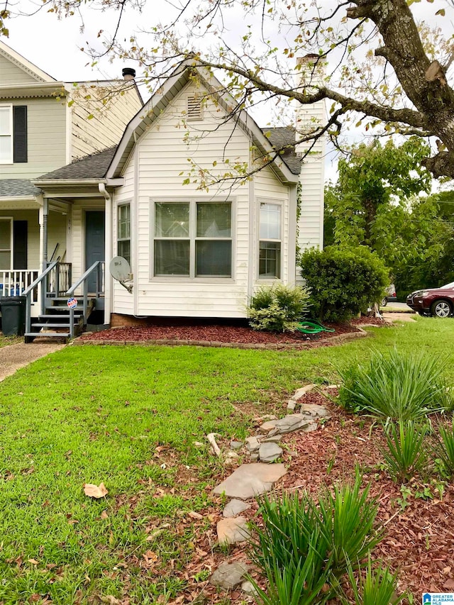 view of property exterior featuring a yard and covered porch