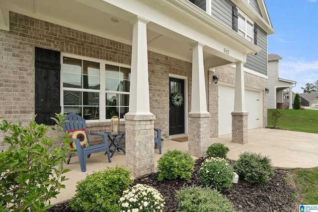 view of patio featuring a garage and a porch