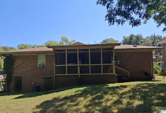 rear view of house featuring cooling unit, a yard, and a sunroom