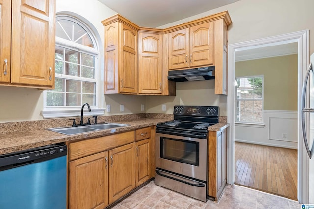 kitchen featuring stainless steel appliances, light wood-type flooring, and sink