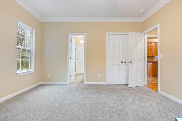 unfurnished bedroom with ornamental molding and light colored carpet