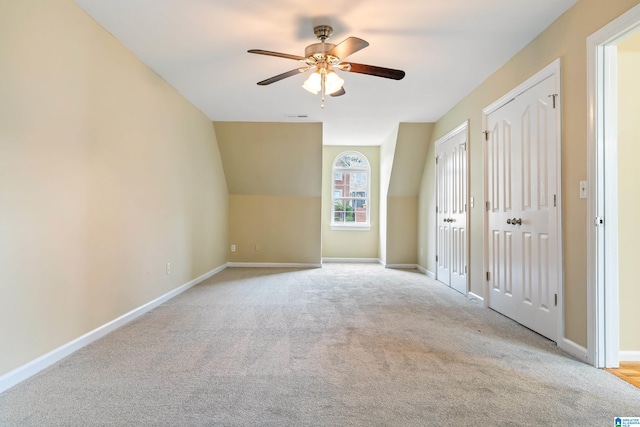 bonus room featuring lofted ceiling, ceiling fan, and light colored carpet