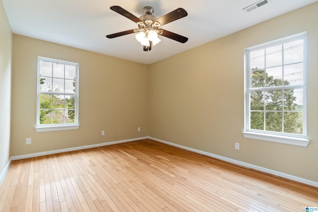 unfurnished room featuring ceiling fan, light hardwood / wood-style flooring, and plenty of natural light