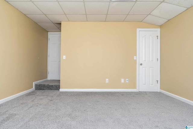 spare room with carpet and a drop ceiling