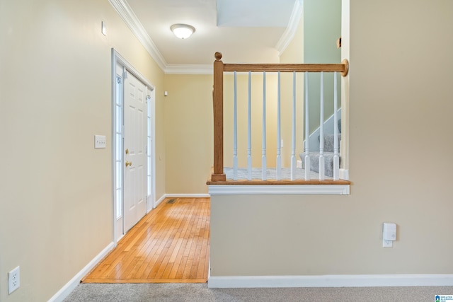 foyer entrance with wood-type flooring and crown molding