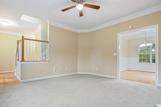 empty room with ceiling fan with notable chandelier, crown molding, and carpet flooring