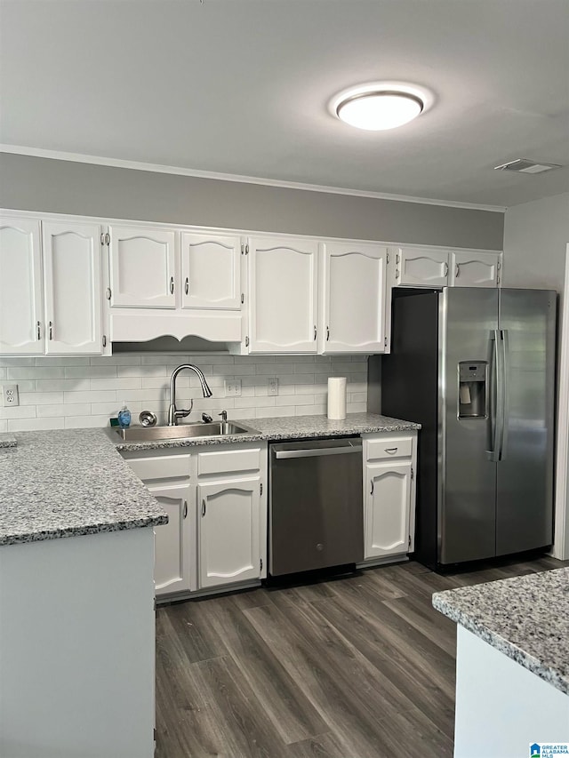 kitchen with white cabinetry, stainless steel appliances, and dark wood-type flooring