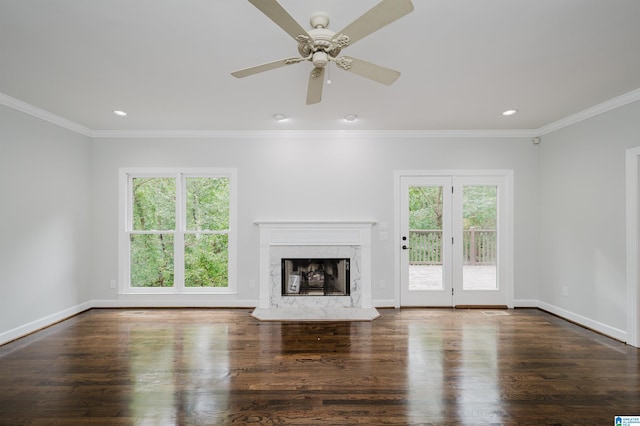 unfurnished living room with dark hardwood / wood-style floors, ceiling fan, and a wealth of natural light