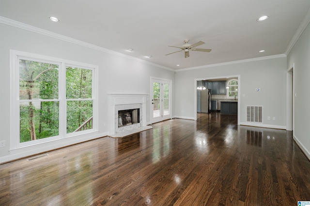 unfurnished living room with a fireplace, ornamental molding, dark hardwood / wood-style flooring, and ceiling fan