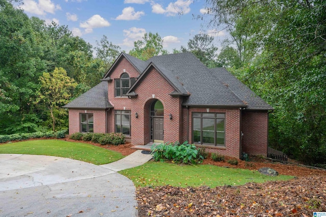 view of property featuring a front lawn