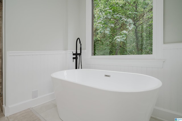 bathroom featuring tile patterned flooring and a bathtub