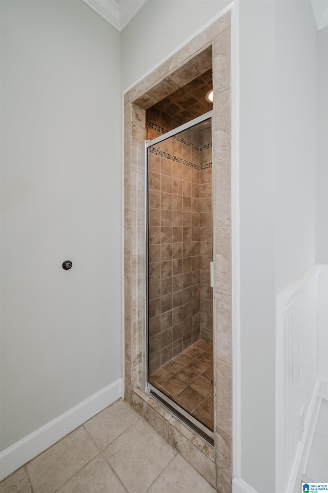 bathroom with ornamental molding, an enclosed shower, and tile patterned floors