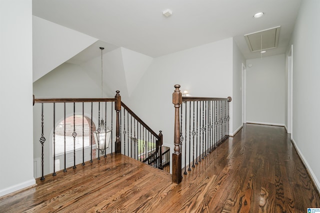 stairs featuring hardwood / wood-style floors