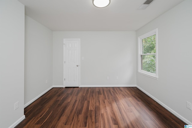 empty room featuring dark hardwood / wood-style flooring