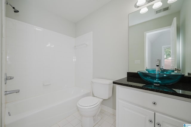 full bathroom featuring vanity, tiled shower / bath combo, toilet, and tile patterned flooring